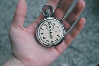 Hand holding a clock